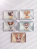 Five rectangular crystal glass fridge magnets featuring cute cartoon illustrations of different dog breeds, arranged on a white textured background